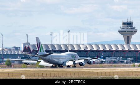 MADRID, SPAIN - APRIL 14, 2019: VAMOS Airlines Boeing 747 passenger plane landing at Madrid-Barajas International Airport Adolfo Suarez . Stock Photo