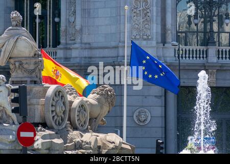 MADRID, SPAIN - MAY 11, 2019: The flags of Spain and the European Union fly in front of the Bank of Spain's headquarters in the famous Plaza de Cibele Stock Photo