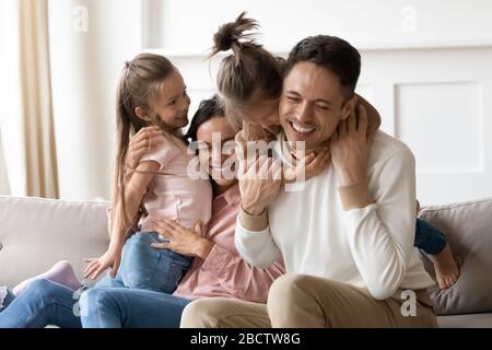 Overjoyed little children playing with happy parents. Stock Photo