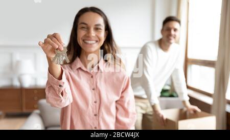 Focus on female hand holding keys from new apartment. Stock Photo
