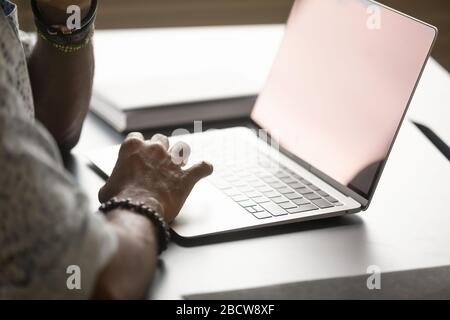 Close up of male worker typing on laptop keyboard Stock Photo