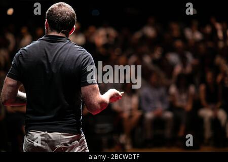 Speaker giving a talk on corporate Business Conference. Audience at the conference hall. Business and Entrepreneurship event. Stock Photo