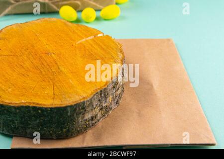 Wooden round board and craft paper on mint background Stock Photo