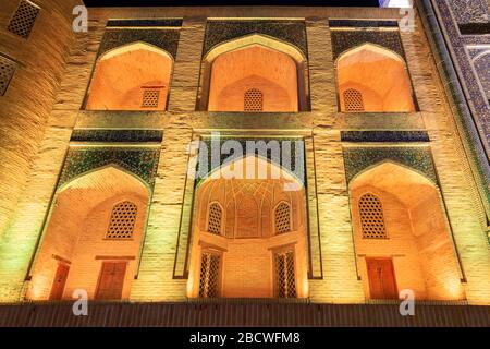 Miri Arab Madrasah facade architectural details. Located in Poi Kalan religious complex in Bukhara, Uzbekistan. Mir-i-Arab Madrassah illuminated night Stock Photo