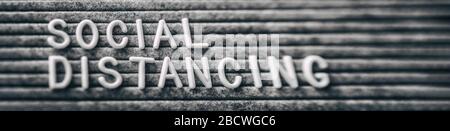 SOCIAL DISTANCING message text on grey felt board Coronavirus outbreak COVID-19 pandemic banner header. Stock Photo