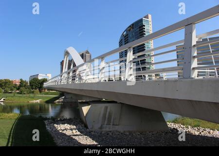 Alexander park Downtown Columbus Ohio green landscape with green trees, concrete walk way , colorful trees city skyline structure ,blue sky Stock Photo