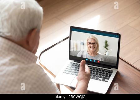 Pc screen view 60s daughter chat with dad by videocall Stock Photo