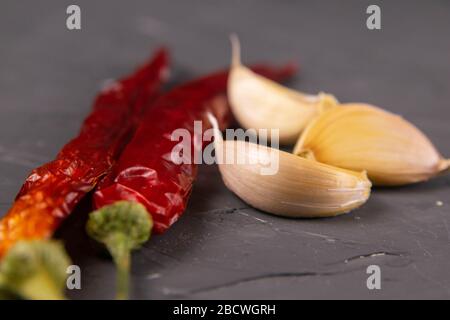 Red hot chili peppers and garlic, isolated on black Stock Photo