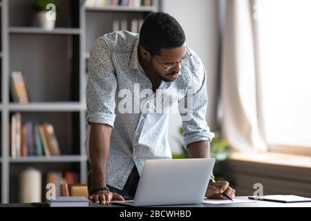 Focused biracial man busy working making notes Stock Photo