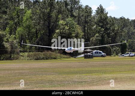 Glider launching in tow behind tractor aircraft Stock Photo