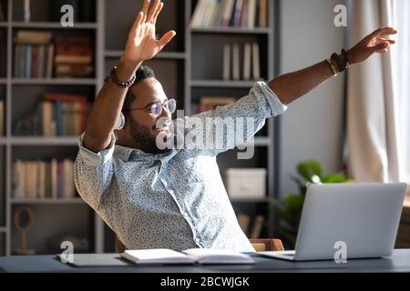 Overjoyed biracial man have fun listening to music Stock Photo