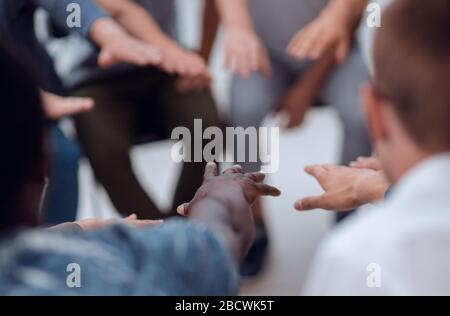 close up. diverse young people joining their palms Stock Photo