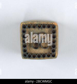 Printing block. Research in ProgressOne of twenty-one wood blocks showing a different floral motif formed by metal strips set in wood. Printing block Stock Photo