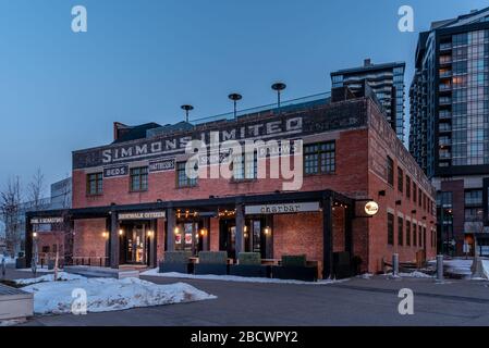 Calgary, Alberta - April 4, 2020: View of the Simmons Building in the evening. Many hip business occupy this building. Stock Photo