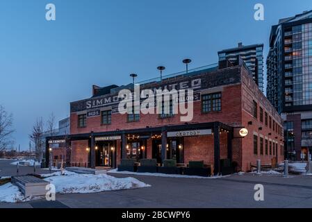 Calgary, Alberta - April 4, 2020: View of the Simmons Building in the evening. Many hip business occupy this building. Stock Photo