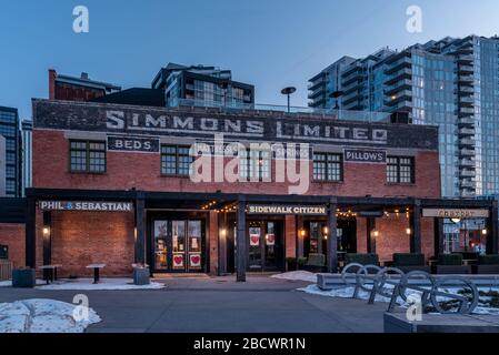 Calgary, Alberta - April 4, 2020: View of the Simmons Building in the evening. Many hip business occupy this building. Stock Photo