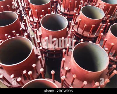 Red gland expansion joints for heating main on concrete floor. Heat and power concept. Stock Photo