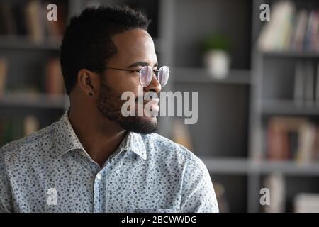 Thoughtful african American man look in distance visualizing Stock Photo
