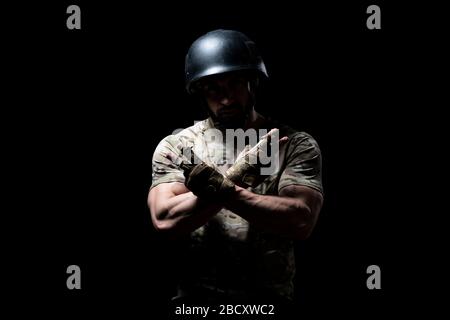 Portrait of a American Marine Corps Special Operations Modern Warfare Soldier With Helmet on Black Background Stock Photo