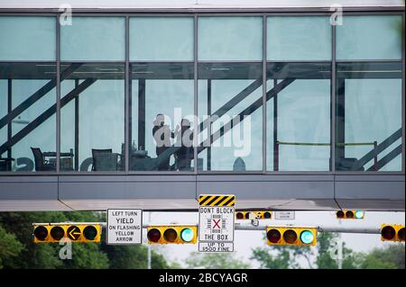 Austin, Texas, USA. 05th Apr, 2020. A person has her temperature taken at an entry station on a footbridge before entering Dell Seton Medical Center at the University of Texas in Austin, Texas. Mario Cantu/CSM/Alamy Live News Stock Photo