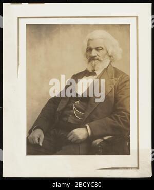 Frederick Douglass. A seated portrait of an older Frederick Douglass. Douglass wears a suit with bow tie, jacket and vest. Frederick Douglass Stock Photo