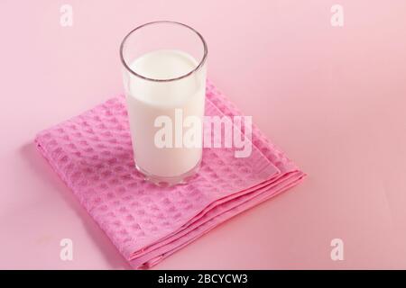 eastern homemade yogurt, kefir or airan in a glass on pink towel. Kefir Lose weight diet concept Stock Photo
