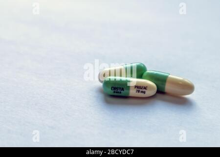 Three 20 mg capsules of the SSRI antidepressant fluoxetine, marketed as Prozac by Eli Lilly and Company (NYSE: LLY). Stock Photo