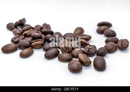 Whole coffee beans on a white background. Selective focus Stock Photo