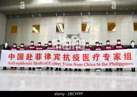 Beijing, China's Fujian Province. 5th Apr, 2020. Medical experts pose for a group photo before departure in Fuzhou, southeast China's Fujian Province, April 5, 2020. A team of 12 medical experts left Fuzhou for the Philippines Sunday morning to aid the archipelagic country to fight the COVID-19 outbreak. Credit: Jiang Kehong/Xinhua/Alamy Live News Stock Photo