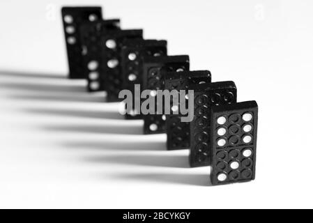 Black Domino blocks with dots forming a diagonal isolated on white background Stock Photo