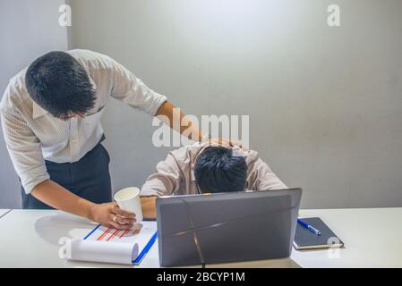 The man consoling his frustrated workmate at office Stock Photo