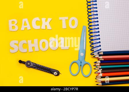 Set of school supplies on the yellow background with the inscription Stock Photo