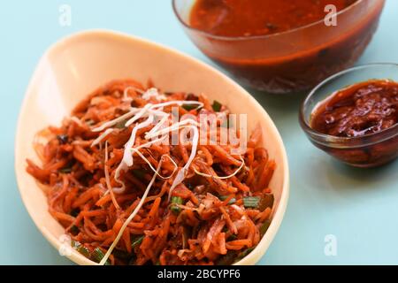 Schezwan Noodles or Manchurian Hakka or vegetable Hakka Noodles or chow mein is a popular indochinese food served in a bowl. Indian Chinese food Stock Photo