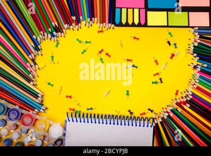 Education background. Supplies for school border on yellow desk Stock Photo