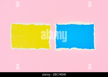 Two ripped paper torn edge sheets on pink background. Template with piece of color paper Stock Photo