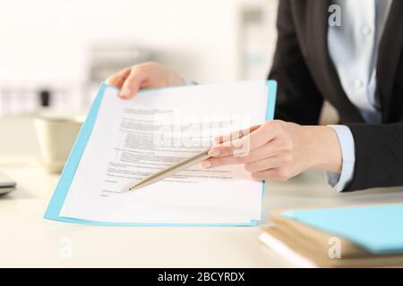 Close up of executive woman hands showing camera contract pointing signature space in the office Stock Photo