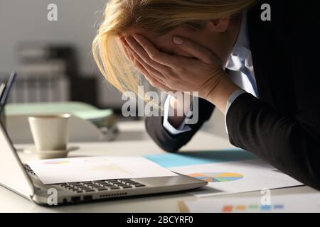 Close up of sad executive woman complaining over bad results at night in the office Stock Photo