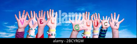 Kids Hands Holding Word Viel Glueck Means Good Luck, Blue Sky Stock Photo