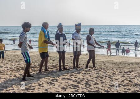 Fisherman Using their fishing rope through their hand on beach.Hardworking fisherman knot. Fishing on beach sand Stock Photo