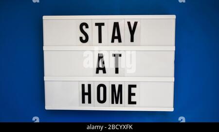 Lightbox with text STAY AT HOME on blue background Stock Photo
