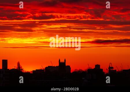 London, UK. 06th Apr, 2020. Blazing sunrise over London looking East towards the Queen Elizabeth II Olympic Park Stratford. Credit: Thamesfleet/Alamy Live News Stock Photo