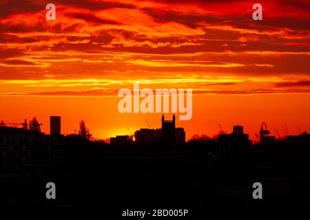 London, UK. 06th Apr, 2020. Blazing sunrise over London looking East towards the Queen Elizabeth II Olympic Park Stratford. Credit: Thamesfleet/Alamy Live News Stock Photo