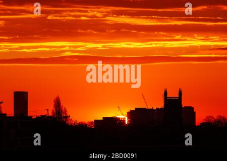 London, UK. 06th Apr, 2020. Blazing sunrise over London looking East towards the Queen Elizabeth II Olympic Park Stratford. Credit: Thamesfleet/Alamy Live News Stock Photo