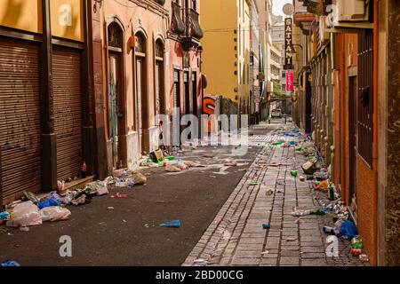 An empty alley full of garbage on the next morning after the Daytime Carnival Stock Photo