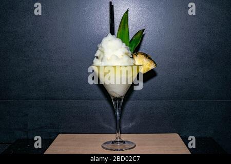 a frozen pina colada fruit cocktail served in a martini glass Stock Photo