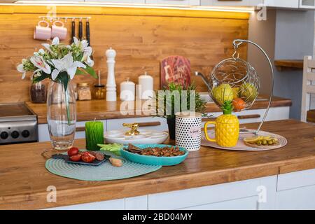 Easter kitchen with food on counter. View over wooden counter set with snacks Stock Photo