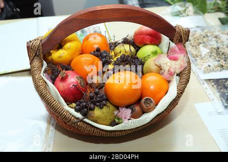 basket are pomegranates, dates, pears, quinces, mashed potatoes, black hawthorn. Stock Photo