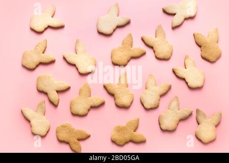 Easter bunnies shaped cookies on pink background. Top view. Abstract pattern. Stock Photo