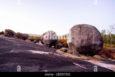 Boulders scattered on the granite rock outcrop at Boulder Rock, Karragullen, Western Australia Stock Photo