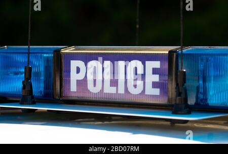 Police sign with blue lights, atop an emergency response patrol vehicle ...